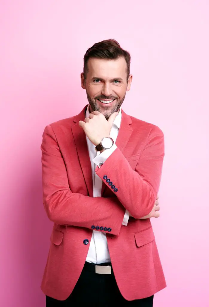 pink smiling man holding his chin 1